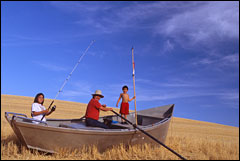 (Photo:  Steve Pettit) Nez Perce fisher James Walker with daughter Alana and son Teewis in a sea of wheat.