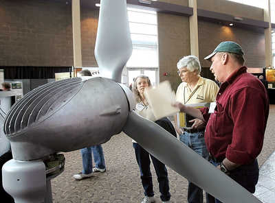 Shelagh and Dennis Bradley, left, of Seattle, talk to Frank Campbell of Sedro Woolley on Sunday at the 10th Harvesting Clean Energy Conference at Three Rivers Convention Center in Kennewick. Around 600 energy industry, agriculture, government and clean energy advocates were at the conference that focused on advancing rural economic development through clean energy production.