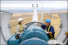 (Joshua Trujillo) Energy Northwest project manager Terry Meade explains the parts of a wind-driven generator to co-worker Angela Curtis atop a 300-foot-high wind turbine tower near Kennewick